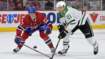 Feb 10, 2024; Montreal, Quebec, CAN; Montreal Canadiens defenseman Kaiden Guhle (21) and Dallas Stars forward Jason Robertson (21) battle for the puck during the third period at the Bell Centre. Mandatory Credit: Eric Bolte-Imagn Images