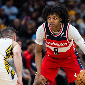 Apr 8, 2025; Indianapolis, Indiana, USA; Washington Wizards guard Bub Carrington (8) dribbles the ball while  Indiana Pacers guard T.J. McConnell (9) defends in the second half at Gainbridge Fieldhouse. Mandatory Credit: Trevor Ruszkowski-Imagn Images