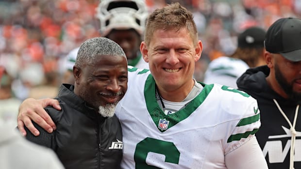 Nick Folk puts an arm around Aaron Glenn after a Jets win.