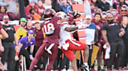 Nov 1, 2025; Blacksburg, Virginia, USA;  .Virginia Tech Hokies safety Isaiah Cash (18) makes a defensive play as Louisville Cardinals wide receiver Caullin Lacy (5) attempts to catch a pass during the fourth quarter at Lane Stadium. Mandatory Credit: Brian Bishop-Imagn Images