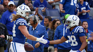Oct 12, 2025; Indianapolis, Indiana, USA; Indianapolis Colts tight end Tyler Warren (84) celebrates with running back Jonathan Taylor (28) after a reception against the Arizona Cardinals during the first quarter of the game at Lucas Oil Stadium.