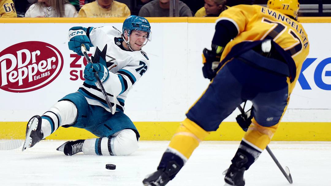 Apr 13, 2026; Nashville, Tennessee, USA; San Jose Sharks left wing William Eklund (72) passes the puck as Nashville Predators right wing Luke Evangelista (77) approaches him during the third period of their game at Bridgestone Arena. Mandatory Credit: Alan Poizner-Imagn Images