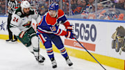 Nov 21, 2024; Edmonton, Alberta, CAN; Edmonton Oilers forward Derek Ryan (10) protects the puck from Minnesota Wild defensemen Zach Bogosian (24) during the third period at Rogers Place. Mandatory Credit: Perry Nelson-Imagn Images