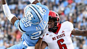 Nov 30, 2024; Chapel Hill, North Carolina, USA; North Carolina Tar Heels defensive back Marcus Allen (29) intercepts the ball in the end zone intended for North Carolina State Wolfpack wide receiver Wesley Grimes (6) in the first quarter at Kenan Memorial Stadium. Mandatory Credit: Bob Donnan-Imagn Images