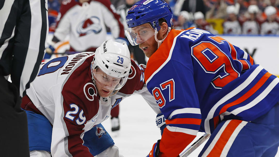 Apr 13, 2026; Edmonton, Alberta, CAN; Edmonton Oilers forward Connor McDavid (97) and Colorado Avalanche forward Nathan MacKinnon (29) battle in a face-off during the second period at Rogers Place. Mandatory Credit: Perry Nelson-Imagn Images