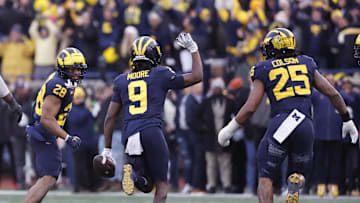Nov 25, 2023; Ann Arbor, Michigan, USA; Michigan Wolverines defensive back Rod Moore (9) celebrates after he makes an interception in the second half against the Ohio State Buckeyes at Michigan Stadium. Mandatory Credit: Rick Osentoski-Imagn Images