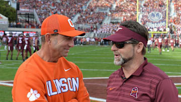 Nov 9, 2024; Blacksburg, Virginia, USA;  Virginia Tech Hokies head coach Brent Pry and Clemson Tigers head coach Dabo Swinney talk before the game at Lane Stadium. Mandatory Credit: Brian Bishop-Imagn Images