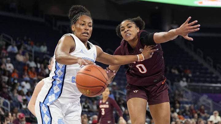 Mar 6, 2026; Duluth, GA, USA; North Carolina Tar Heels guard Indya Nivar (24) and Virginia Tech Hokies forward Kilah Freelon (0) fight for the ball during the first half at Gas South Arena. Mandatory Credit: Dale Zanine-Imagn Images