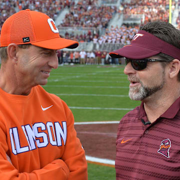 Nov 9, 2024; Blacksburg, Virginia, USA;  Virginia Tech Hokies head coach Brent Pry and Clemson Tigers head coach Dabo Swinney talk before the game at Lane Stadium. Mandatory Credit: Brian Bishop-Imagn Images