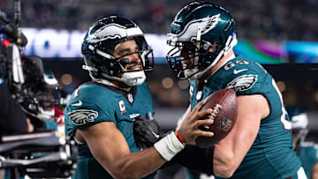 Dec 15, 2024; Philadelphia, Pennsylvania, USA; Philadelphia Eagles quarterback Jalen Hurts (1) celebrates with offensive tackle Lane Johnson (65) after his touchdown against the Pittsburgh Steelers during the fourth quarter at Lincoln Financial Field. Mandatory Credit: Bill Streicher-Imagn Images