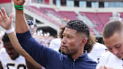Sep 27, 2025; Fayetteville, Arkansas, USA; Notre Dame Fighting Irish head coach Marcus Freeman leads the team in celebration after the game against the Arkansas Razorbacks at Donald W. Reynolds Razorback Stadium. Notre Dame won 56-13. 