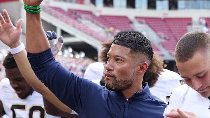 Sep 27, 2025; Fayetteville, Arkansas, USA; Notre Dame Fighting Irish head coach Marcus Freeman leads the team in celebration after the game against the Arkansas Razorbacks at Donald W. Reynolds Razorback Stadium. Notre Dame won 56-13. 