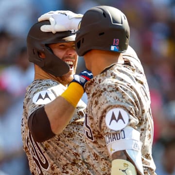 Jul 4, 2025; San Diego, California, USA; San Diego Padres third baseman Manny Machado (13) celebrates with San Diego Padres left fielder Gavin Sheets (30) after hitting a one run home run during the fourth inning against the Texas Rangers at Petco Park. Mandatory Credit: David Frerker-Imagn Images