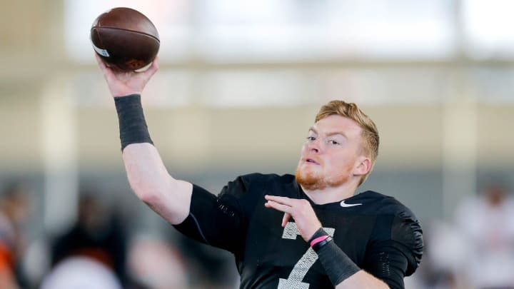 Alan Bowman (7) runs drills during an Oklahoma State football practice