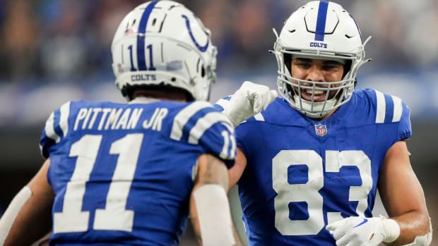 Colts tight end Kylen Granson (blue jersey with white helmet) celebrates with a teammate after a big play. 