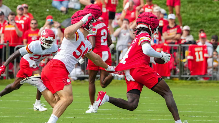Jul 22, 2025; St. Joseph, MO, USA; Kansas City Chiefs wide receiver Rashee Rice (4) catches a pass as linebacker Leo Chenal (54) defends during training camp at Missouri Western State University. Mandatory Credit: Denny Medley-Imagn Images
