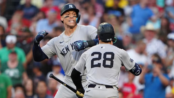 New York Yankees catcher Austin Wells (28) congratulates New York Yankees designated hitter Aaron Judge.