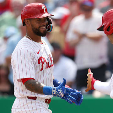 Mar 9, 2025; Clearwater, Florida, USA; Philadelphia Phillies shortstop Edmundo Sosa (33) celebrates after hitting a home run with infielder Otto Kemp (82) against the Baltimore Orioles in the third inning during spring trining at BayCare Ballpark