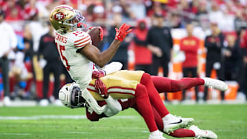Jan 5, 2025; Glendale, Arizona, USA; San Francisco 49ers wide receiver Jauan Jennings (15) is tackled by Arizona Cardinals cornerback Garrett Williams (21) at State Farm Stadium. Mandatory Credit: Mark J. Rebilas-Imagn Images