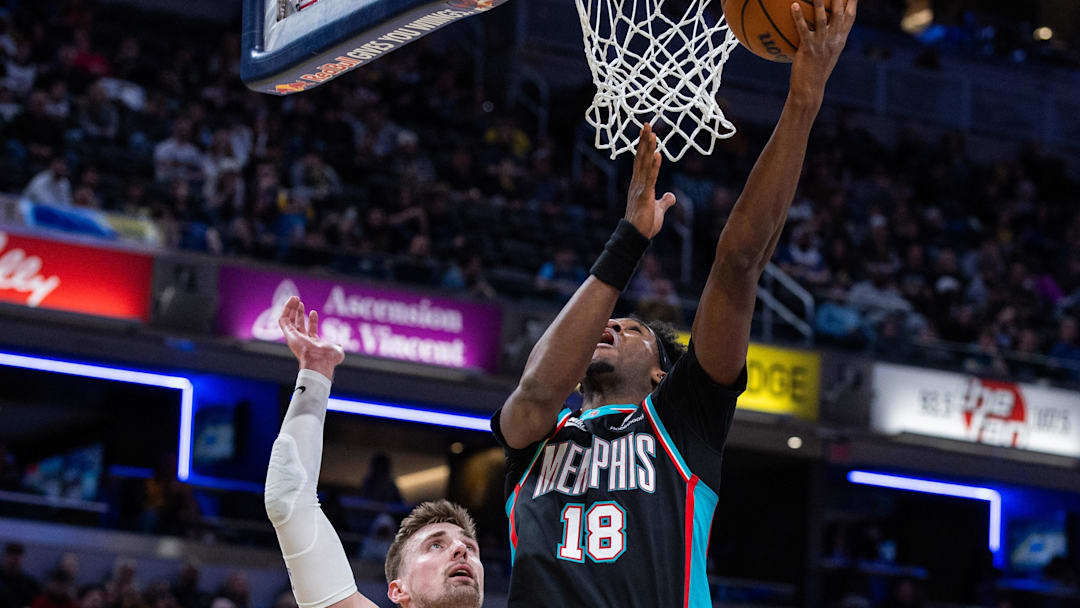 Mar 1, 2026; Indianapolis, Indiana, USA; Memphis Grizzlies forward Olivier-Maxence Prosper (18) shoots the ball while  Indiana Pacers center Micah Potter (11) defends in the second half at Gainbridge Fieldhouse. Mandatory Credit: Trevor Ruszkowski-Imagn Images
