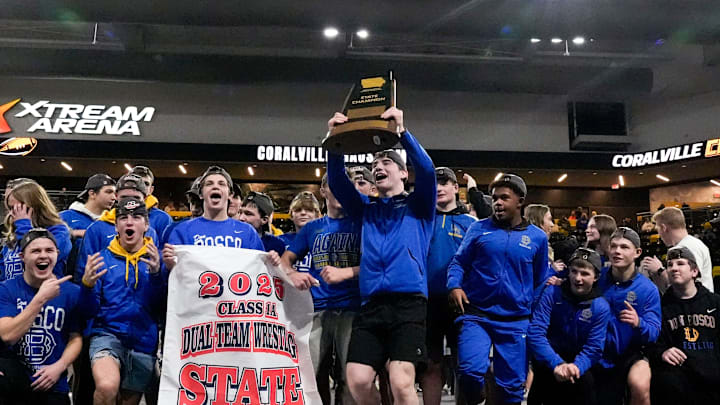 Don Bosco wrestlers hoist the Class 1A championship trophy at the IHSAA State Dual Tournament Saturday, Feb. 8, 2025 at Xtream Arena in Coralville, Iowa. Don Bosco wrestlers hoist the Class 1A championship trophy at the IHSAA State Dual Tournament Saturday, Feb. 8, 2025 at Xtream Arena in Coralville, Iowa.