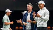 Rory McIlroy and Tiger Woods watch golfers warm up for the inaugural match at SoFi Center, the home of TGL, the interactive golf league founded by Woods and McIlroy on January 7, 2025 in Palm Beach Gardens, Florida.