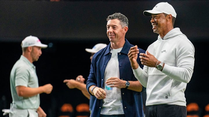 Rory McIlroy and Tiger Woods watch golfers warm up for the inaugural match at SoFi Center, the home of TGL, the interactive golf league founded by Woods and McIlroy on January 7, 2025 in Palm Beach Gardens, Florida. Rory McIlroy and Tiger Woods watch golfers warm up for the inaugural match at SoFi Center, the home of TGL, the interactive golf league founded by Woods and McIlroy on January 7, 2025 in Palm Beach Gardens, Florida.