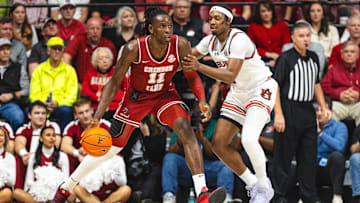 Feb 15, 2025; Tuscaloosa, Alabama, USA; Alabama Crimson Tide center Clifford Omoruyi (11) controls the ball as Auburn Tigers guard Denver Jones (2) defends during the first half at Coleman Coliseum. Mandatory Credit: Will McLelland-Imagn Images
