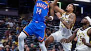 Oct 11, 2025; Indianapolis, Indiana, USA; Oklahoma City Thunder guard Jazian Gortman (14) shoots the ball while Indiana Pacers forward Jalen Slawson (18) defends in the second half at Gainbridge Fieldhouse. Mandatory Credit: Trevor Ruszkowski-Imagn Images