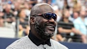 Sep 15, 2024; Arlington, Texas, USA; Former NBA player Shaquille O'Neal stands on the sidelines before a game between the New Orleans Saints and Dallas Cowboys at AT&T Stadium. Mandatory Credit: Tim Heitman-Imagn Images