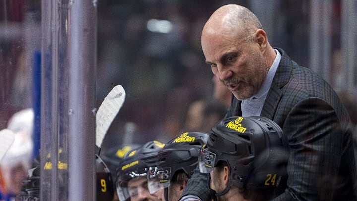 Jan 18, 2025; Vancouver, British Columbia, CAN;  Vancouver Canucks head coach Rick Tocchet speaks with forward Pius Suter (24) on the bench against the Edmonton Oilers in the second period at Rogers Arena.