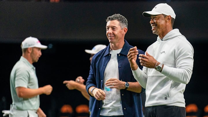 Rory McIlroy and Tiger Woods watch golfers warm up at TGL event in Florida
