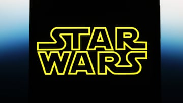 In this photo illustration, a Star Wars logo is seen on a...