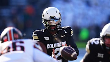 Nov 29, 2024; Boulder, Colorado, USA; Colorado Buffaloes quarterback Shedeur Sanders (2) takes a hike in the first quarter against the Oklahoma State Cowboys at Folsom Field. Mandatory Credit: Ron Chenoy-Imagn Images
