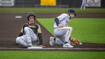 Oshkosh North Spartan senior Greyson Spanbauer (20) slides into third Wausau West Warrior freshman Miles Waldvogel (21) catches the ball during a non-conference baseball game at Wausau West High School in Wausau, Wisconsin on Friday, April 26, 2024. Oshkosh won 4-3.