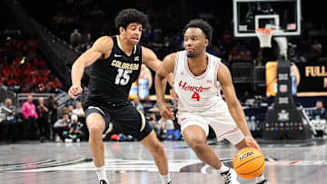 Mar 13, 2025; Kansas City, MO, USA; Houston Cougars guard L.J. Cryer (4) drives to the basket around Colorado Buffaloes guard Felix Kossaras (15) during the first half at T-Mobile Center. Mandatory Credit: William Purnell-Imagn Images
