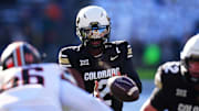 Nov 29, 2024; Boulder, Colorado, USA; Colorado Buffaloes quarterback Shedeur Sanders (2) takes a hike in the first quarter against the Oklahoma State Cowboys at Folsom Field. Mandatory Credit: Ron Chenoy-Imagn Images