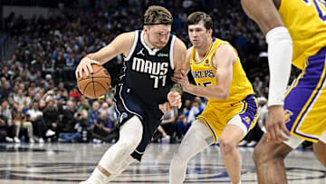 Dec 12, 2023; Dallas, Texas, USA; Dallas Mavericks guard Luka Doncic (77) and Los Angeles Lakers guard Austin Reaves (15) in action during the game between the Dallas Mavericks and the Los Angeles Lakers at the American Airlines Center. Mandatory Credit: Jerome Miron-Imagn Images