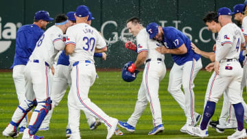 Jul 22, 2024; Arlington, Texas, USA; Texas Rangers left fielder Wyatt Langford (36) is mobbed by teammates after hitting a walk-off RBI single against the Chicago White Sox at Globe Life Field. Mandatory Credit: Raymond Carlin III-USA TODAY Sports