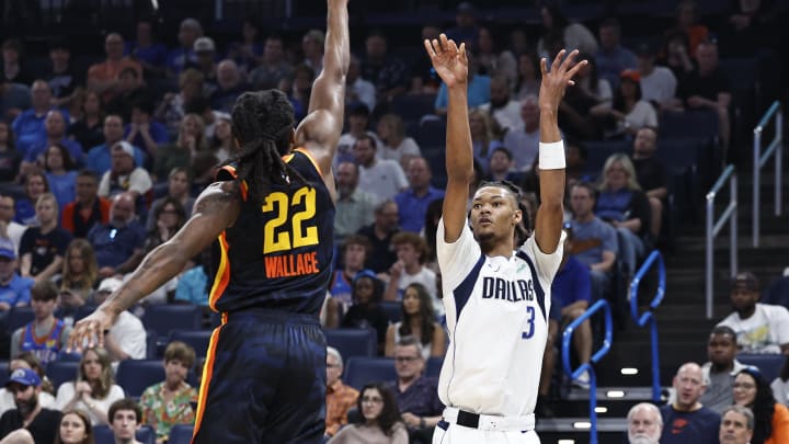 Apr 14, 2024; Oklahoma City, Oklahoma, USA; Dallas Mavericks forward Alex Fudge (3) shoots as Oklahoma City Thunder guard Cason Wallace (22) defends during the second quarter at Paycom Center. Mandatory Credit: Alonzo Adams-USA TODAY Sports