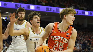 Dec 6, 2024; Evanston, Illinois, USA; Northwestern Wildcats guard Brooks Barnhizer (13) defends Illinois Fighting Illini guard Kasparas Jakucionis (32) during the first half at Welsh-Ryan Arena. Mandatory Credit: David Banks-Imagn Images