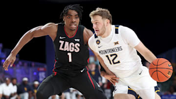 West Virginia Mountaineers guard Tucker DeVries (12) drives to the basket as Gonzaga Bulldogs guard Michael Ajayi (1) defends during the first half at the Atlantis Resort.