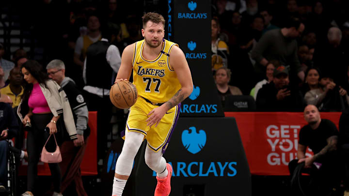 Mar 10, 2025; Brooklyn, New York, USA; Los Angeles Lakers guard Luka Doncic (77) brings the ball up court against the Brooklyn Nets during the first quarter at Barclays Center. Mandatory Credit: Brad Penner-Imagn Images