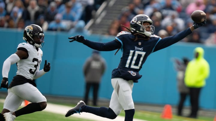 Tennessee Titans wide receiver DeAndre Hopkins (10) hauls in a one-handed grab against Jacksonville Jaguars cornerback Darious Williams (31) in the first quarter of their game at Nissan Stadium in Nashville, Tenn., Sunday, Jan. 7, 2024.