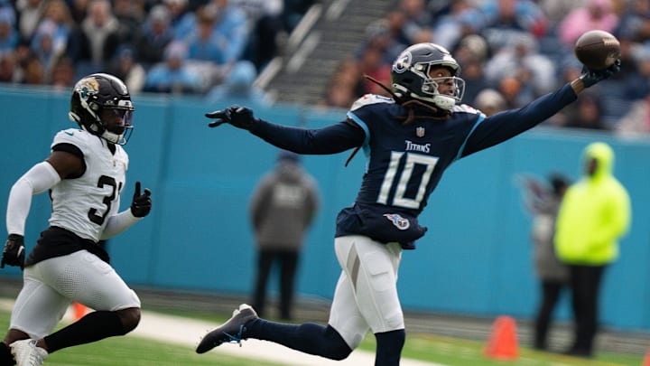 Tennessee Titans wide receiver DeAndre Hopkins (10) hauls in a one-handed grab against Jacksonville Jaguars cornerback Darious Williams (31) in the first quarter of their game at Nissan Stadium in Nashville, Tenn., Sunday, Jan. 7, 2024.