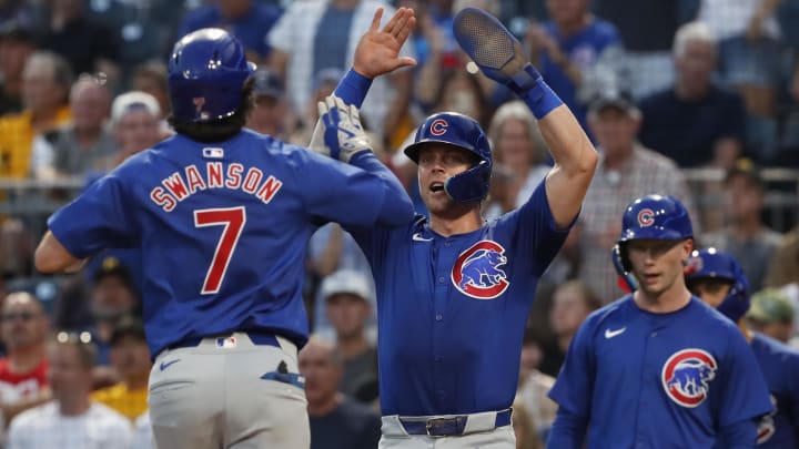 Aug 27, 2024; Pittsburgh, Pennsylvania, USA;  Chicago Cubs second baseman Nico Hoerner (middle) greets shortstop Dansby Swanson (7) crossing home plate on a two run home run against the Pittsburgh Pirates during the fourth inning at PNC Park.