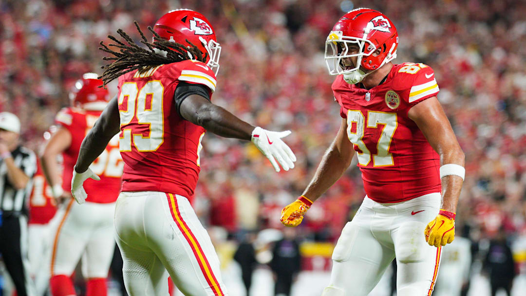 Oct 7, 2024; Kansas City, Missouri, USA; Kansas City Chiefs running back Kareem Hunt (29) celebrates with tight end Travis Kelce (87) after scoring a touchdown during the first half against the New Orleans Saints at GEHA Field at Arrowhead Stadium. Mandatory Credit: Jay Biggerstaff-Imagn Images