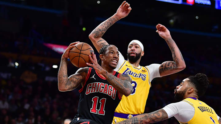 Jan 25, 2024; Los Angeles, California, USA; Chicago Bulls forward DeMar DeRozan (11) moves the ball against Los Angeles Lakers forward Anthony Davis (3) and guard D'Angelo Russell (1) during the second half at Crypto.com Arena. Mandatory Credit: Gary A. Vasquez-Imagn Images