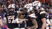 Dec 27, 2023; Houston, TX, USA; Oklahoma State Cowboys running back Ollie Gordon II (0) celebrates his rushing touchdown with teammates against the Texas A&M Aggies in the second quarter at NRG Stadium. Mandatory Credit: Thomas Shea-USA TODAY Sports