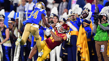 Nov 19, 2022; Pasadena, California, USA; UCLA Bruins defensive back Jaylin Davies (24) breaks up a pass intended for Southern California Trojans wide receiver Kyle Ford (81) during the first half at the Rose Bowl. Mandatory Credit: Gary A. Vasquez-Imagn Images